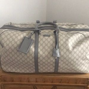 Gucci supreme trolley rolling duffle bag luggage.